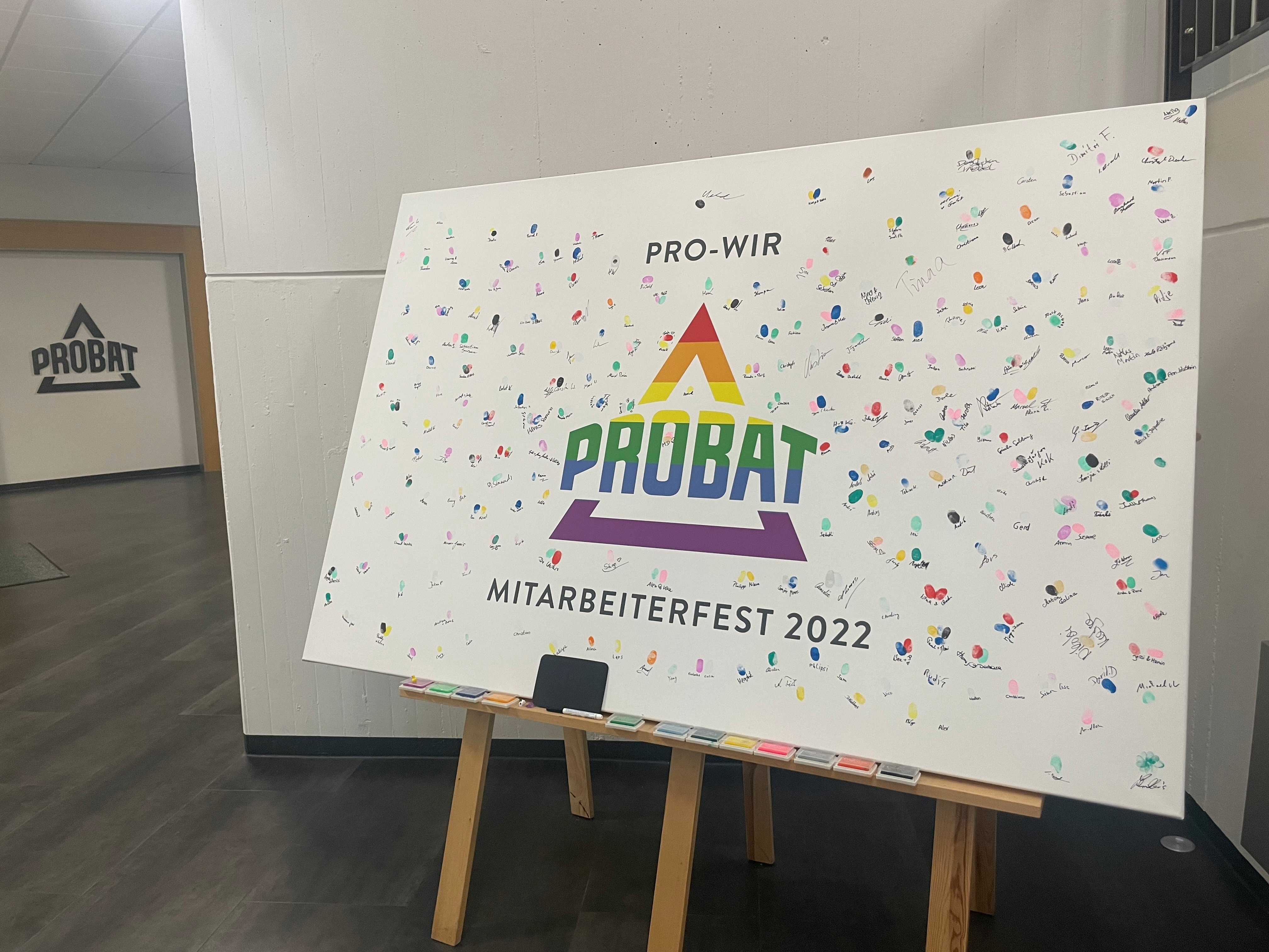 Fingerprints of PROBAT employees on a canvas in Pride colors with a colorful logo