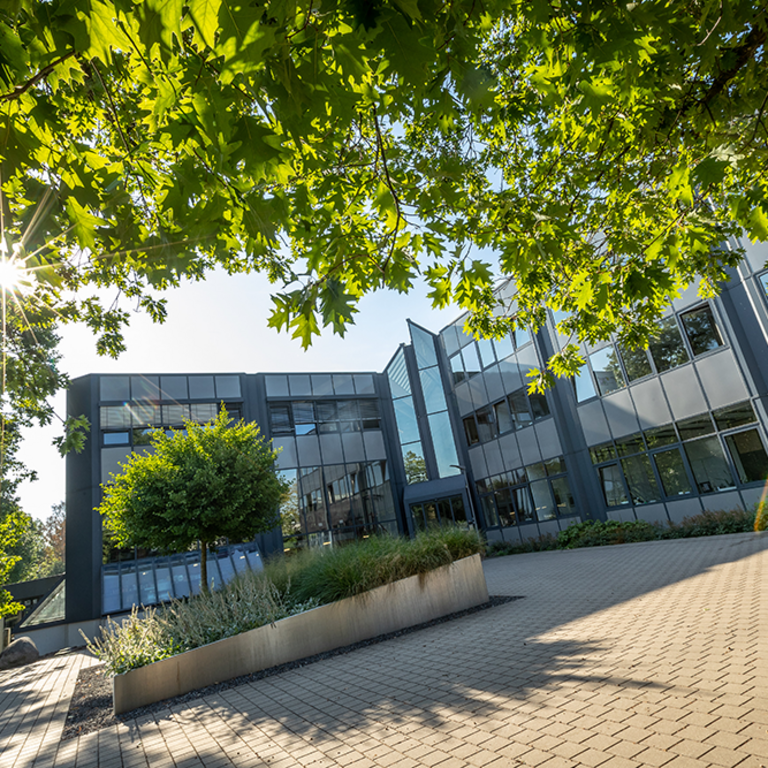 The PROBAT administration building, the main entrance framed by a tree 