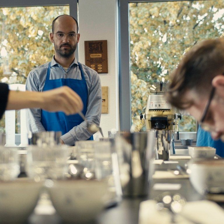 People in a cupping session at the technology center