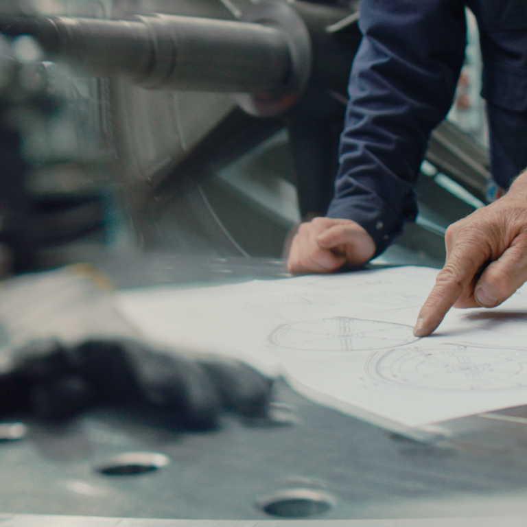 PROBAT certificates Hands pointing on paper plan in factory