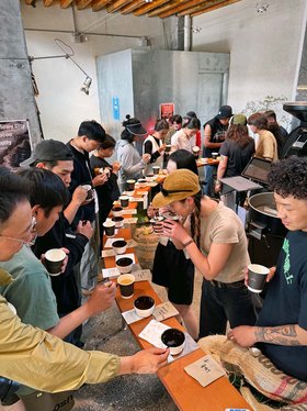 Espresso Master Roaster Beans The picture shows man people at an exhibition testing roasting beans.